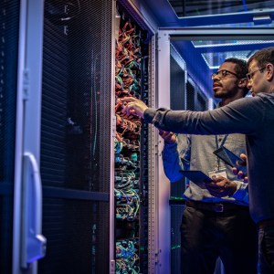 IT engineers checking servers in server room